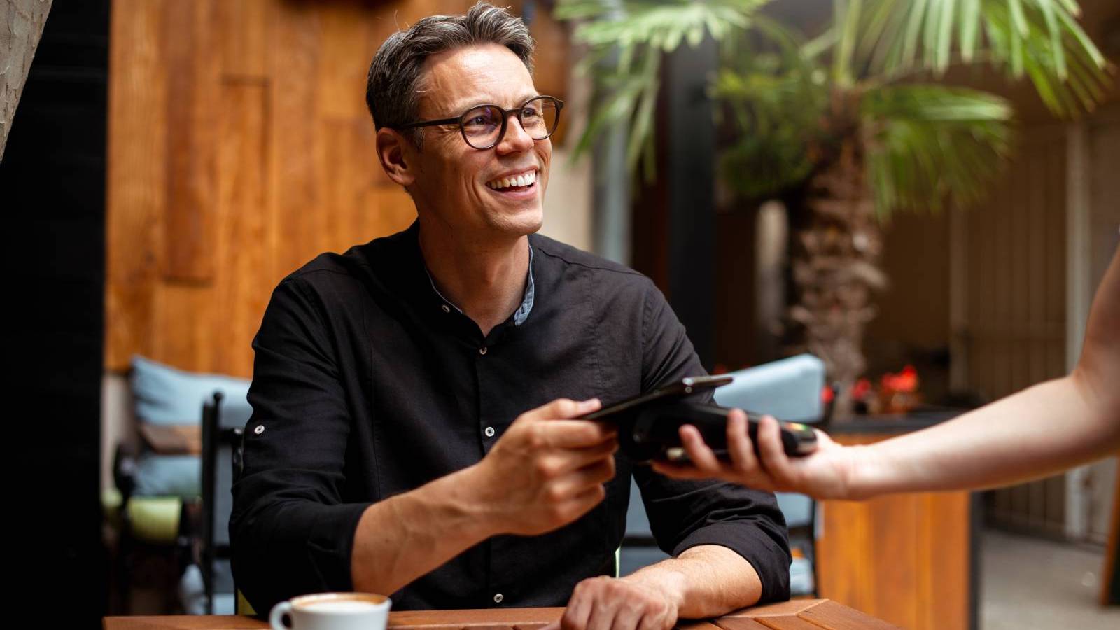 man making contactless payment