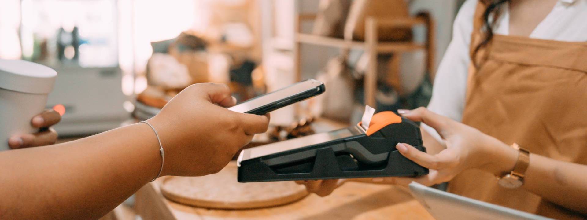 person paying contactless with mobile 